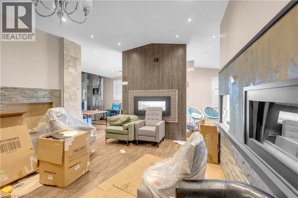 Spacious interior featuring wood-finish flooring, recessed lighting, and a modern chandelier