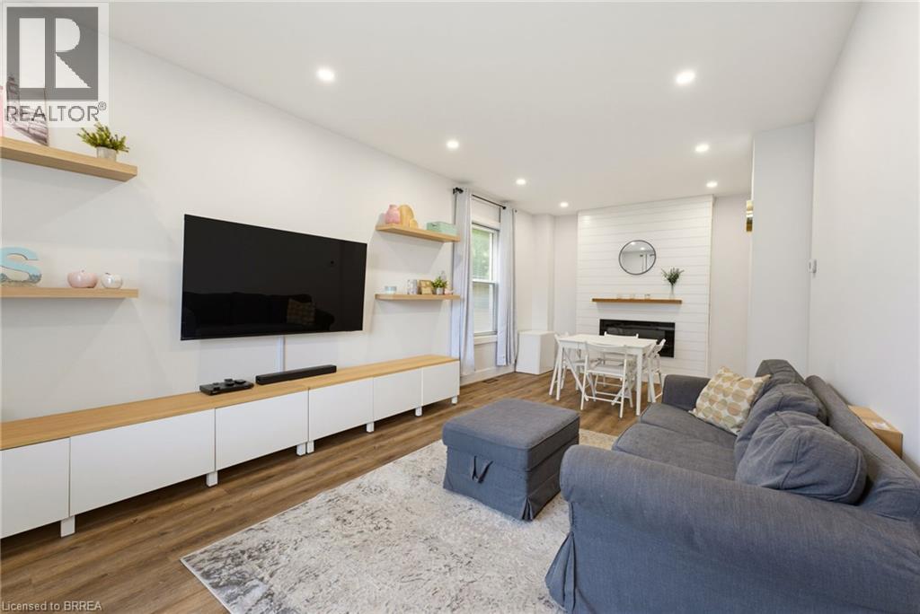 Recessed lighting, wood-finish flooring, and white walls create a bright atmosphere