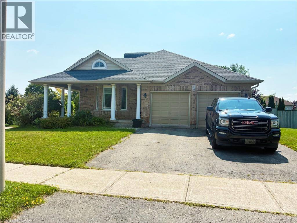 Brick exterior with a covered front porch, an arched window, and a dual garage