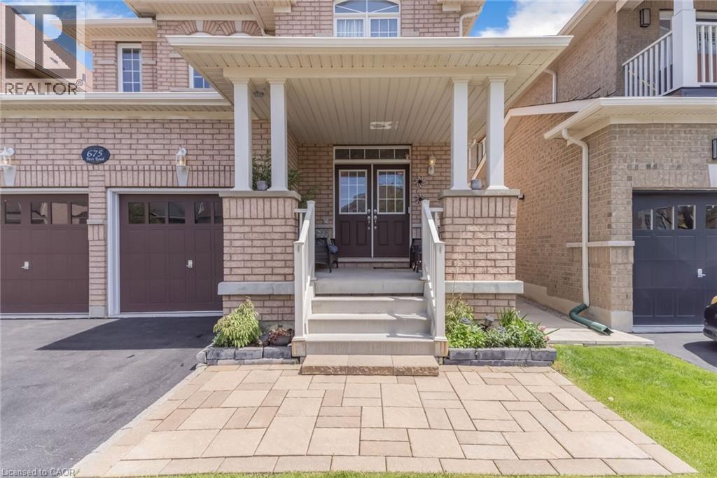 Brick facade with a covered porch featuring white columns and railing