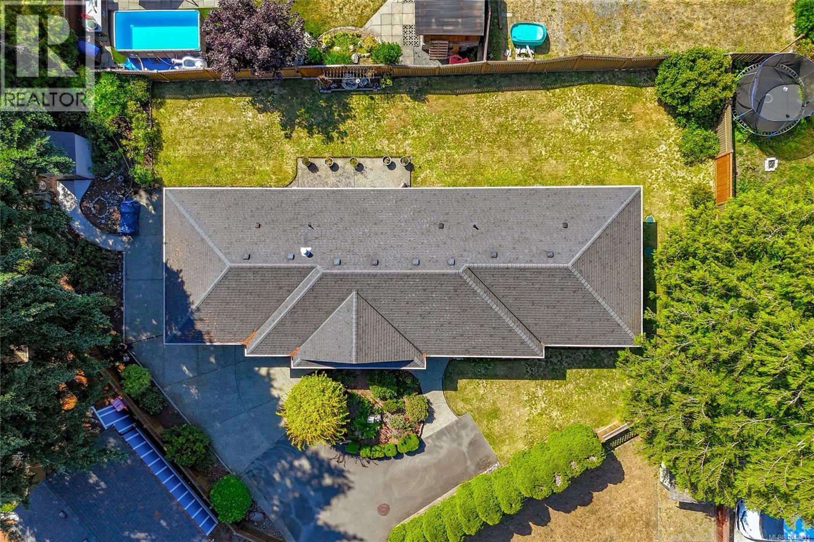Aerial view showcasing the spacious, level lot and beautifully maintained one-level home.