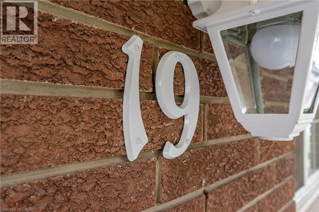 Red brick exterior with white house numbers