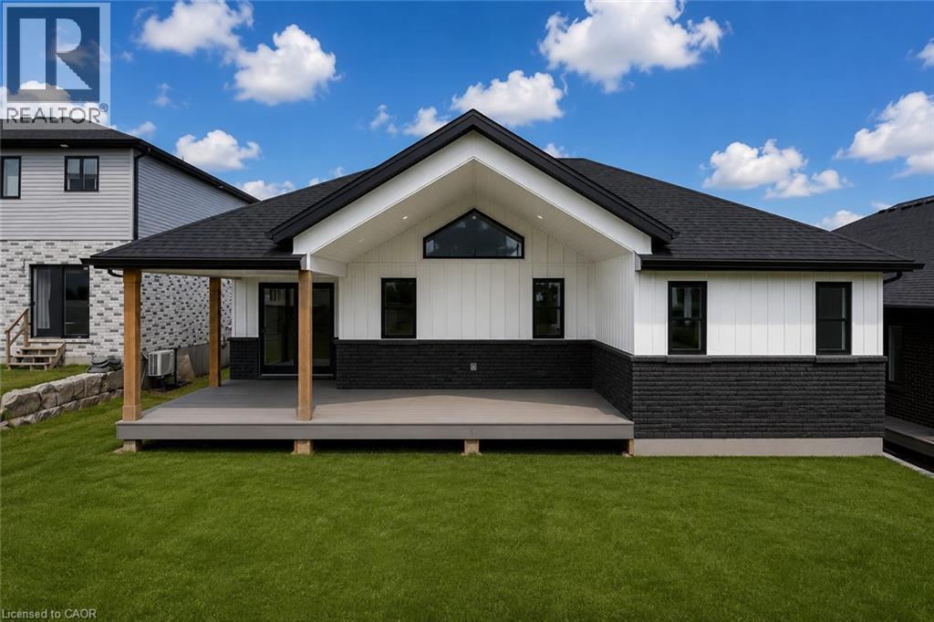 AI Generated pic of actual home plan. Expansive backyard with a manicured lawn, featuring a covered deck supported by wood posts, and a black shingle roof