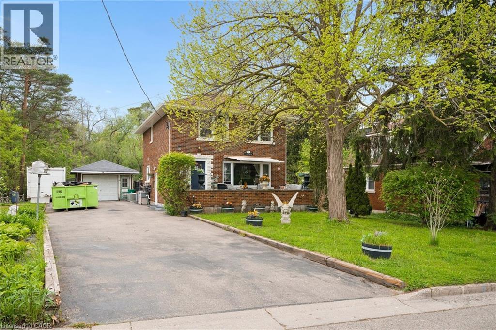 Brick exterior featuring stone window sills and a bay window