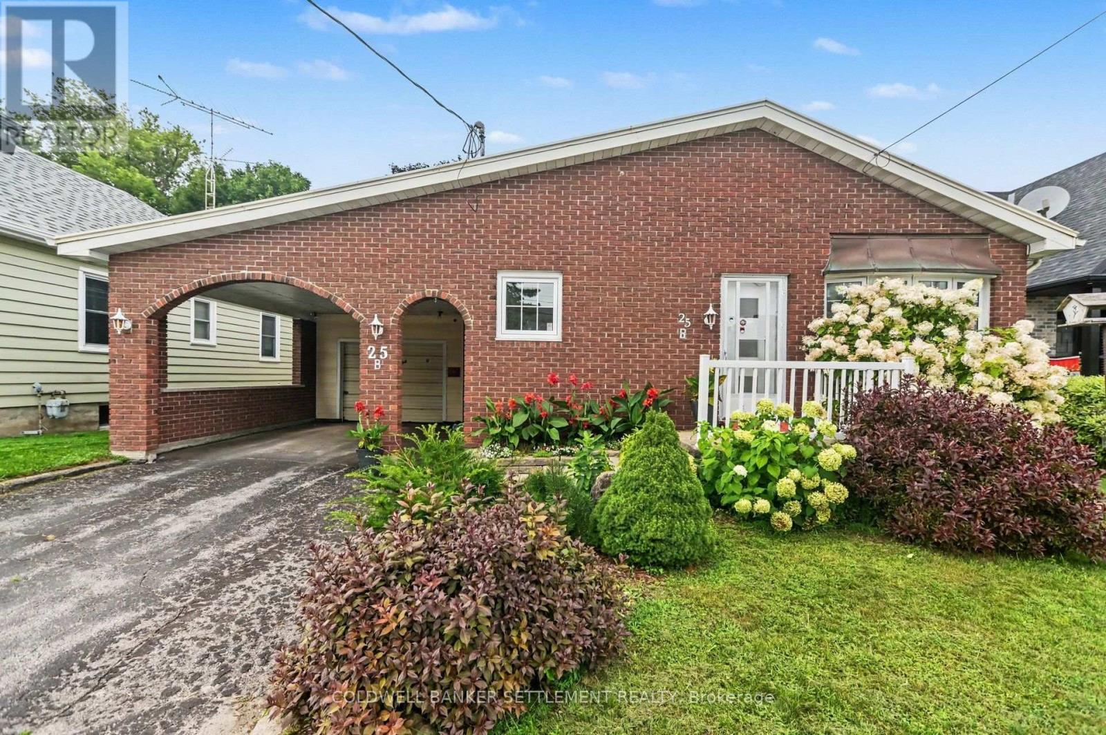 Front showing carport and garage