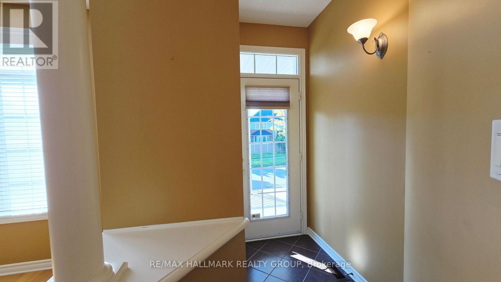 Tile foyer has a coat closet & lovely entry door