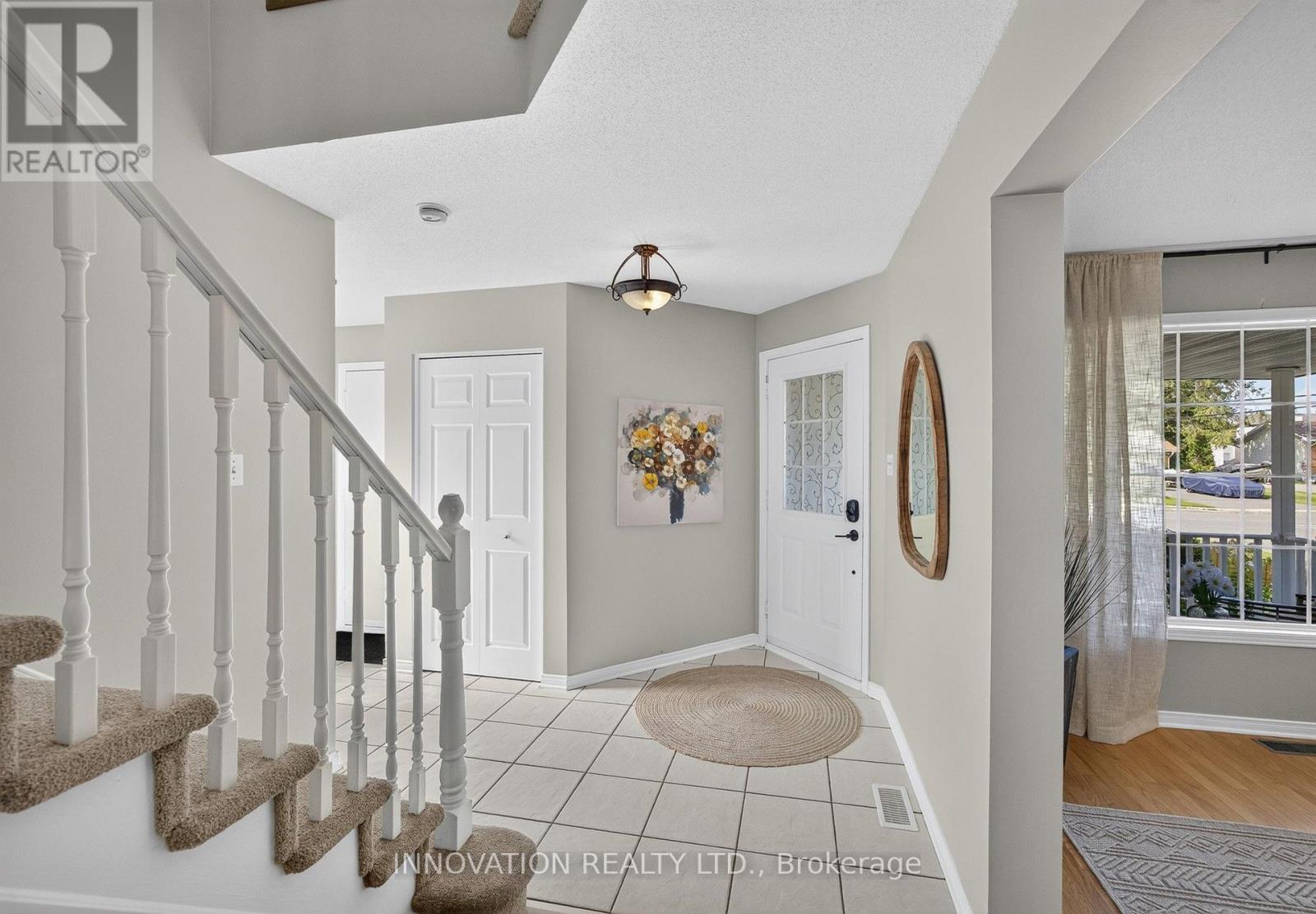Foyer with view of inside-entry to garage at left