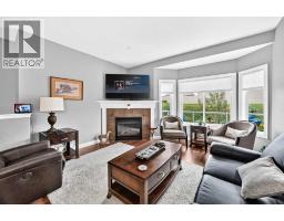 Family room - 84 River Heights View, Cochrane, AB T4C0E6 Photo 8