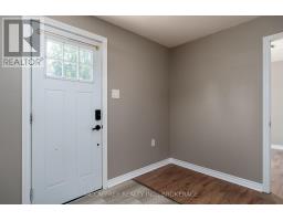 White front door with keypad lock and wood-look flooring - 2956 County Road 14 Stone Mills