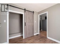 Sliding barn door and wood flooring hallway - 2956 County Road 14 Stone Mills