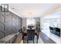 Dining room with geometric wall and open concept to kitchen with island - 109 Woodcroft Lane Vaughan