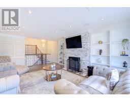 Living room with stone fireplace and mounted TV - 109 Woodcroft Lane Vaughan