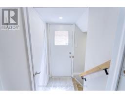 Hallway with white door, frosted window, and wood flooring - 109 Woodcroft Lane Vaughan