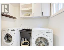 LG washer, dryer, and utility sink in modern laundry room - 109 Woodcroft Lane Vaughan