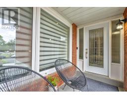 Modern chairs on porch with decorative glass front door and zebra blinds - 109 Woodcroft Lane Vaughan