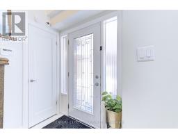 Entryway with glass paneled front door and potted plant - 109 Woodcroft Lane Vaughan