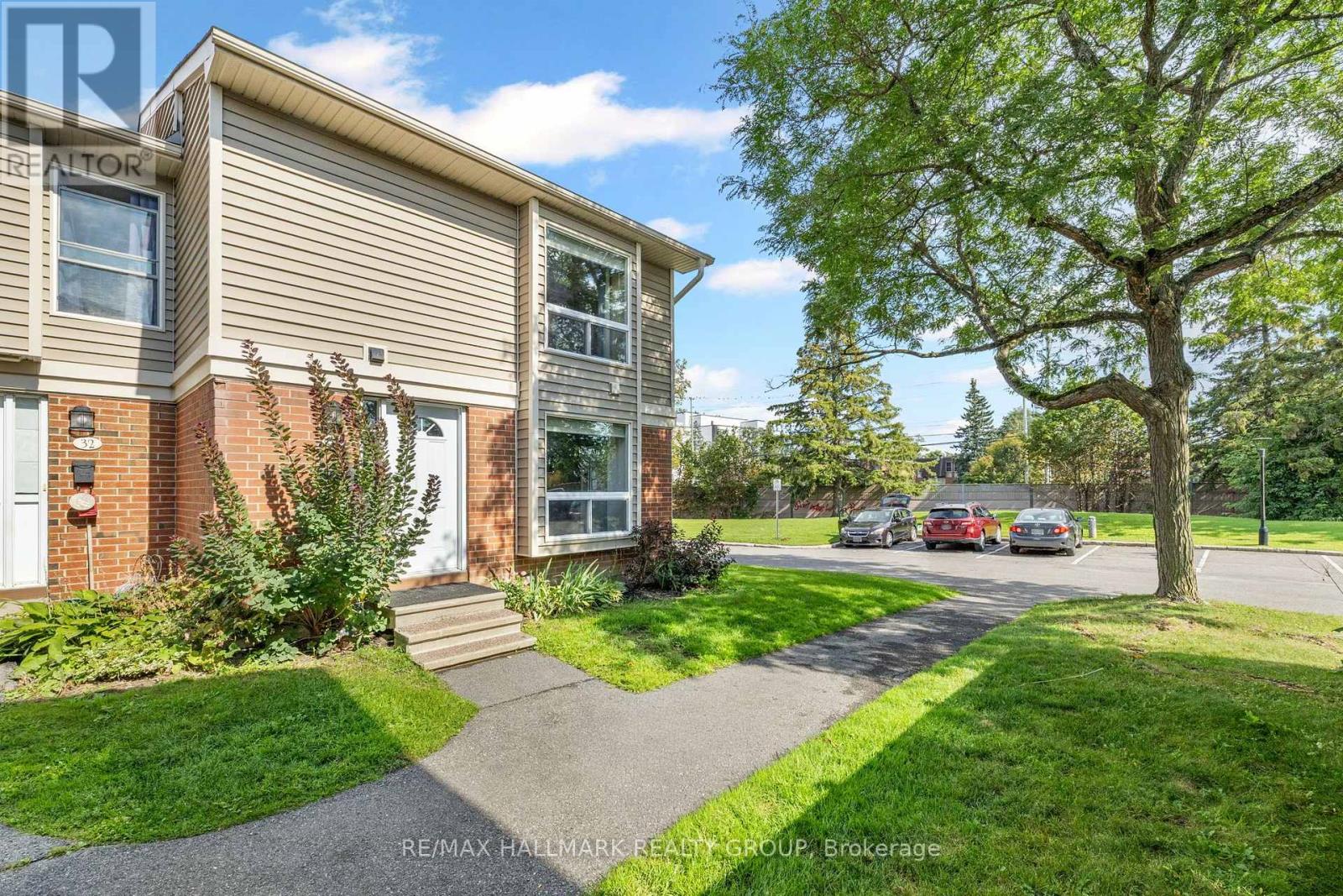 End-unit exterior with mature shade tree
