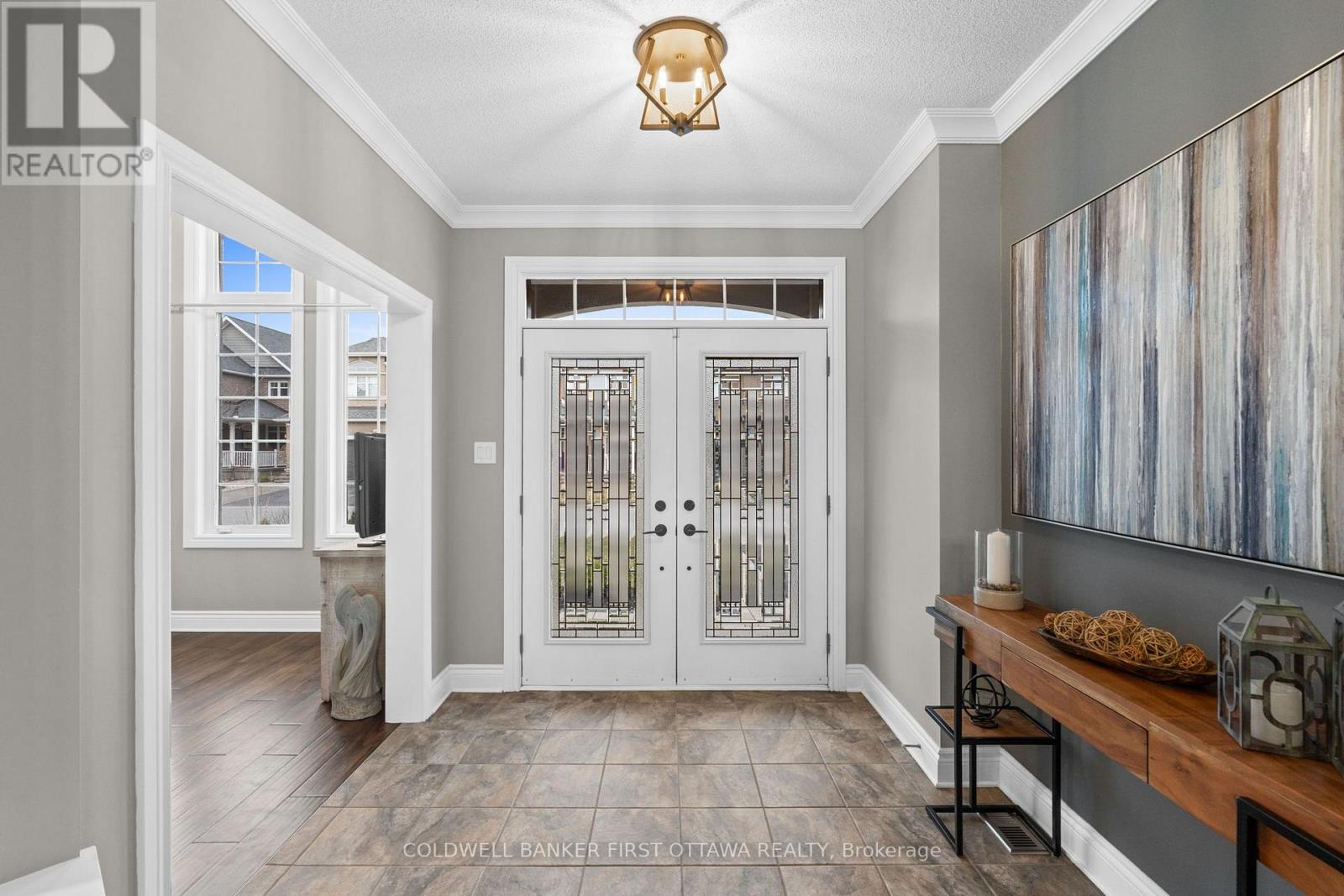 Grand front foyer w/ ceramic tiles & fireplace.