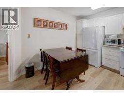 Living room - 101, 6800 Hunterview Drive Nw, Calgary, AB T2K6K5 Photo 9