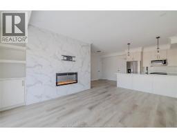 Living room/Fireplace - 1740 A Sprucewood Avenue Unit# 301, Lasalle, ON N9J0E6 Photo 7