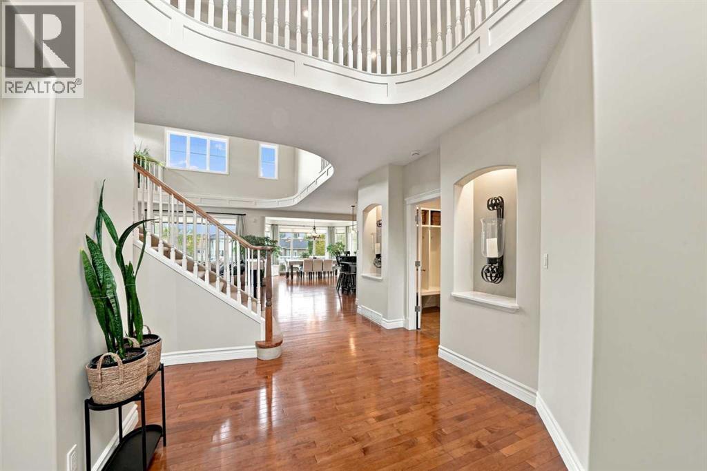 View towards the grand open-concept main living area that showcases raised ceilings, maple hardwood flooring and abundant natural light