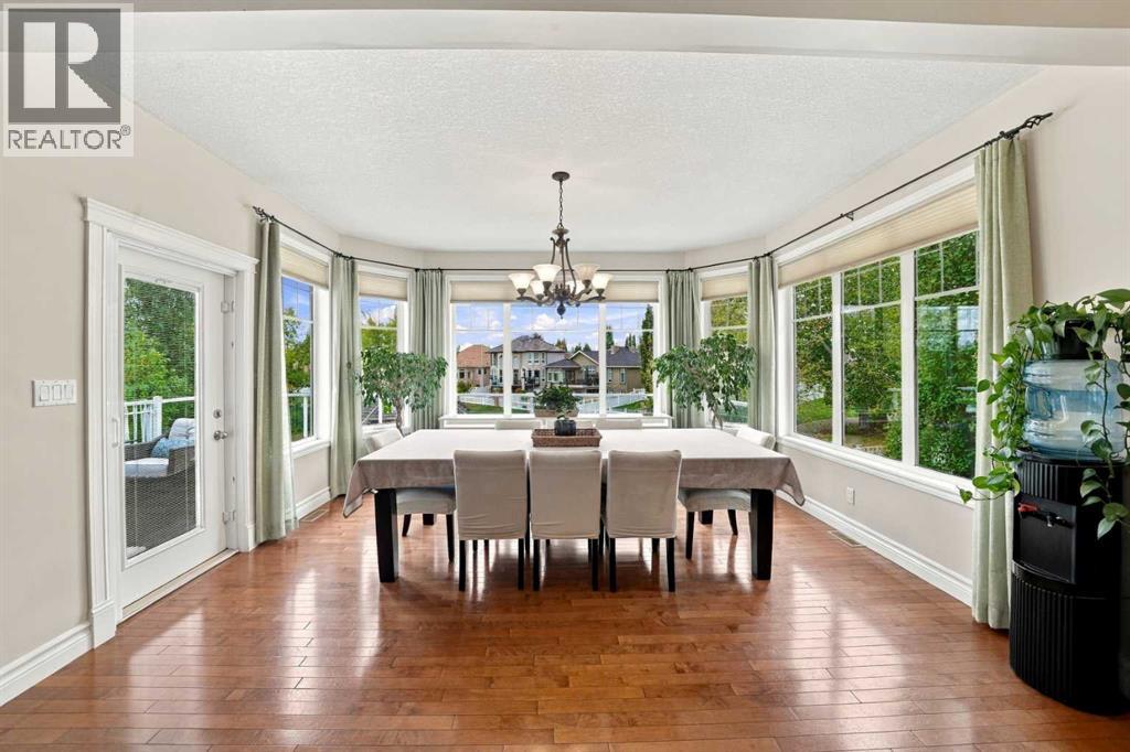 The spacious dining area, surrounded by windows, is perfect for large gatherings with family and friends