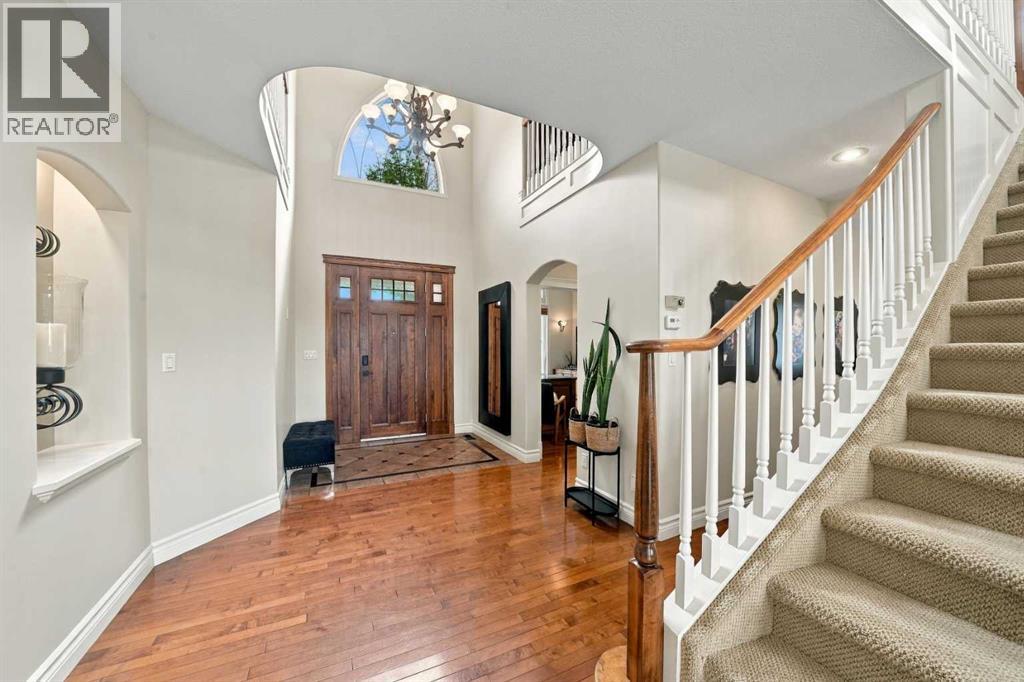 The front entrance features a handcrafted walnut front door