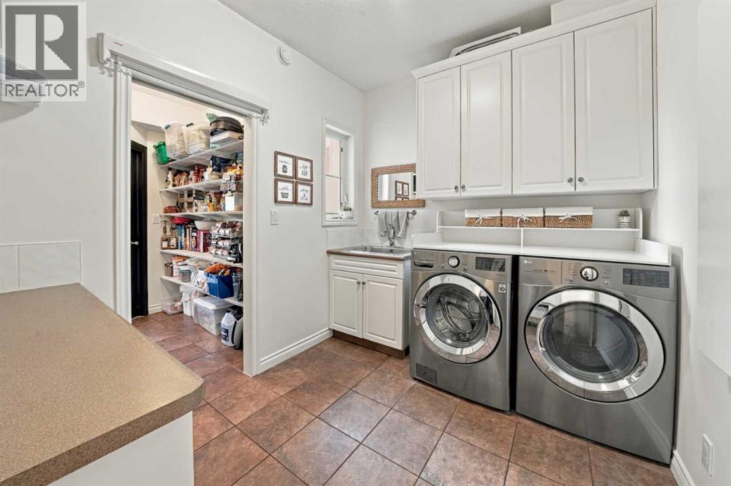 Main level laundry room with the walk-through kitchen pantry in the background