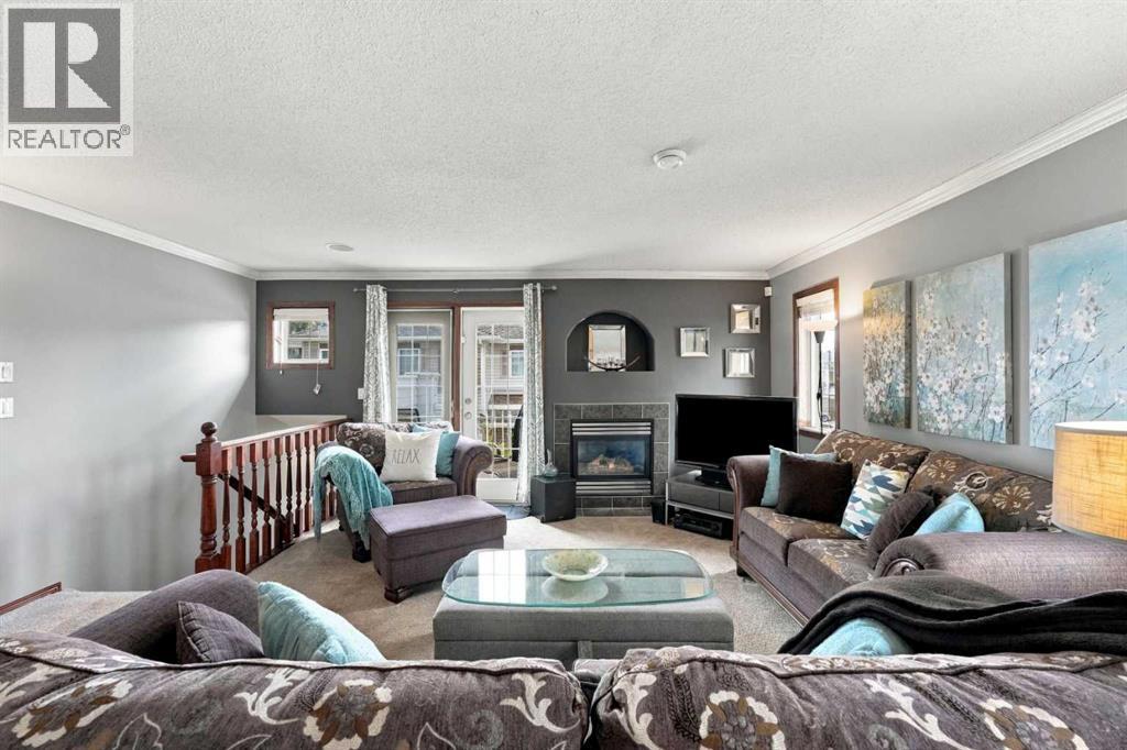 The spacious living room is centred around a stylish gas fireplace that creates an inviting focal point