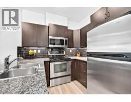 Living room - 4203, 11811 Lake Fraser Drive Se, Calgary, AB T2J1J7 Photo 6