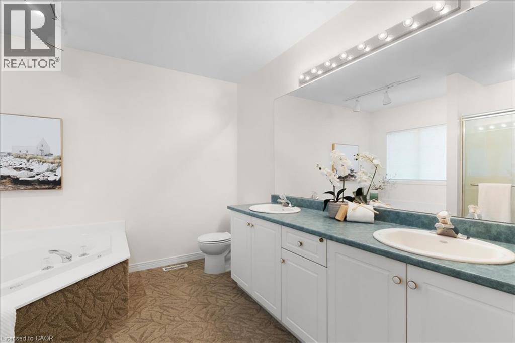 Double vanity with dual basins, built-in cabinetry, and a large wall-mounted mirror