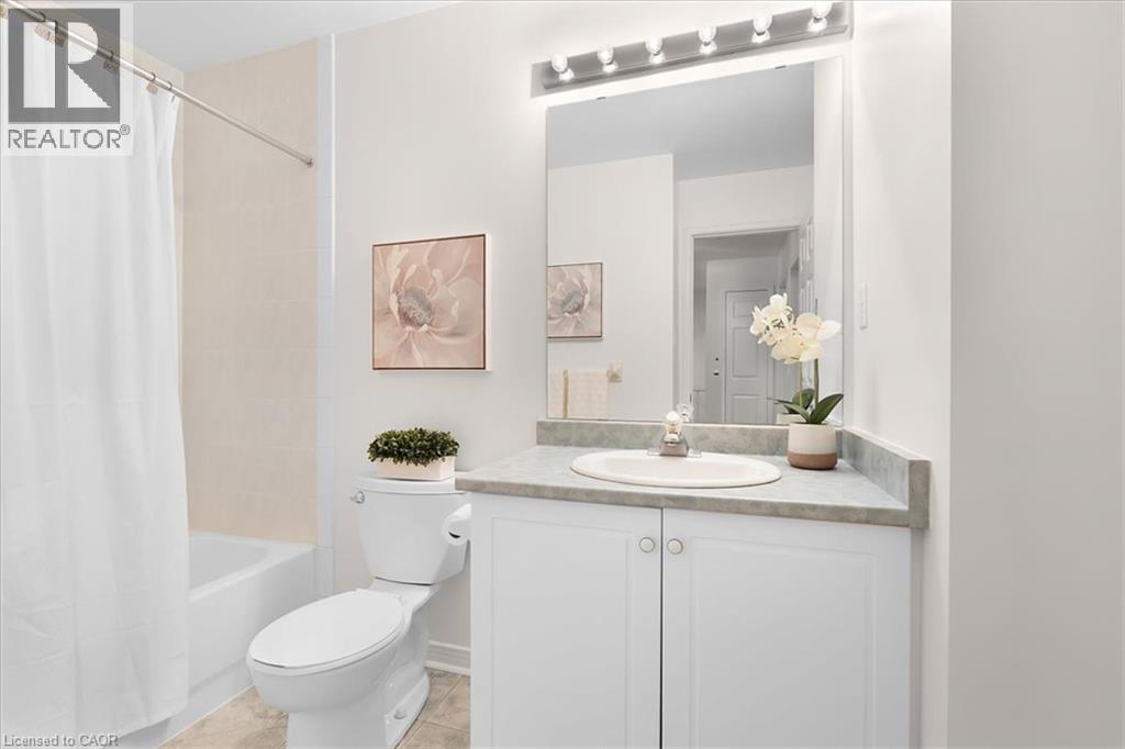 White vanity with cabinet storage, integrated sink, and a framed mirror