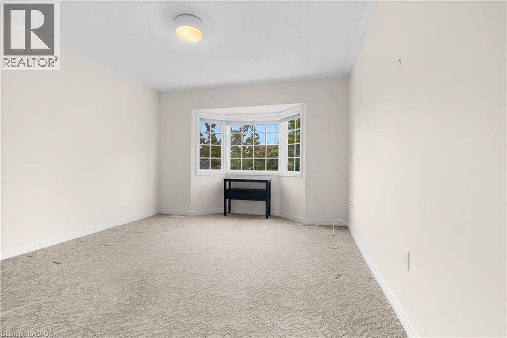 Bay window with multiple panes, light neutral wall finishes, and ceiling-mounted light fixture
