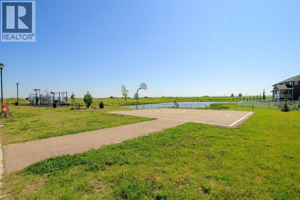 Park, playgorund and walking trail around a pond