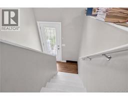 Foyer / Entry stairway to main floor (digitally edited to remove tenant furnishings and personal belongings only)