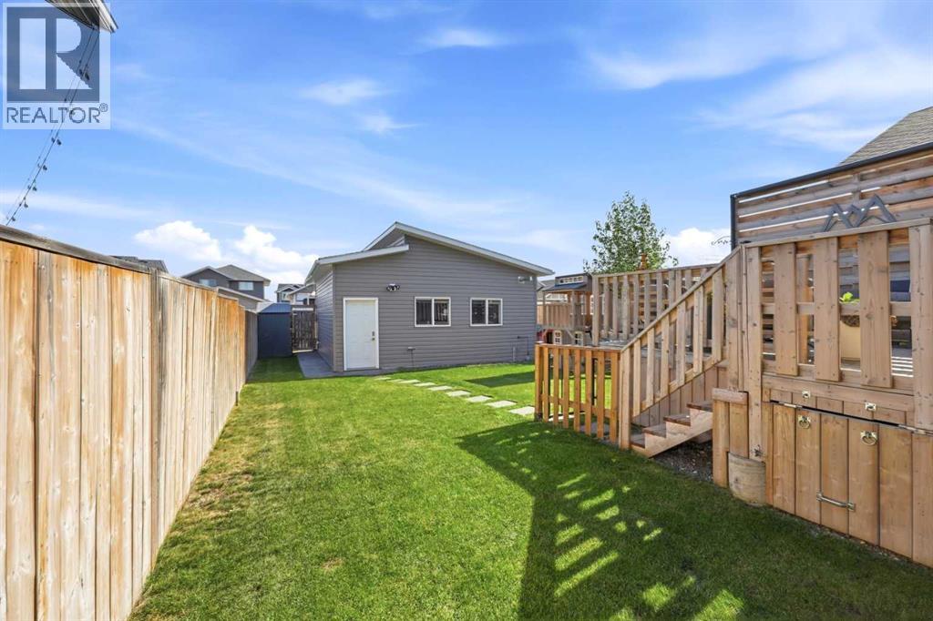 View of backyard and entrance to detached heated double garage