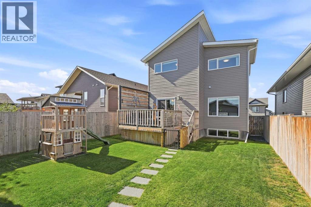 Modern rooflines, wood-grain siding accents, a covered composite front porch, and stone detailing create impressive curb appeal