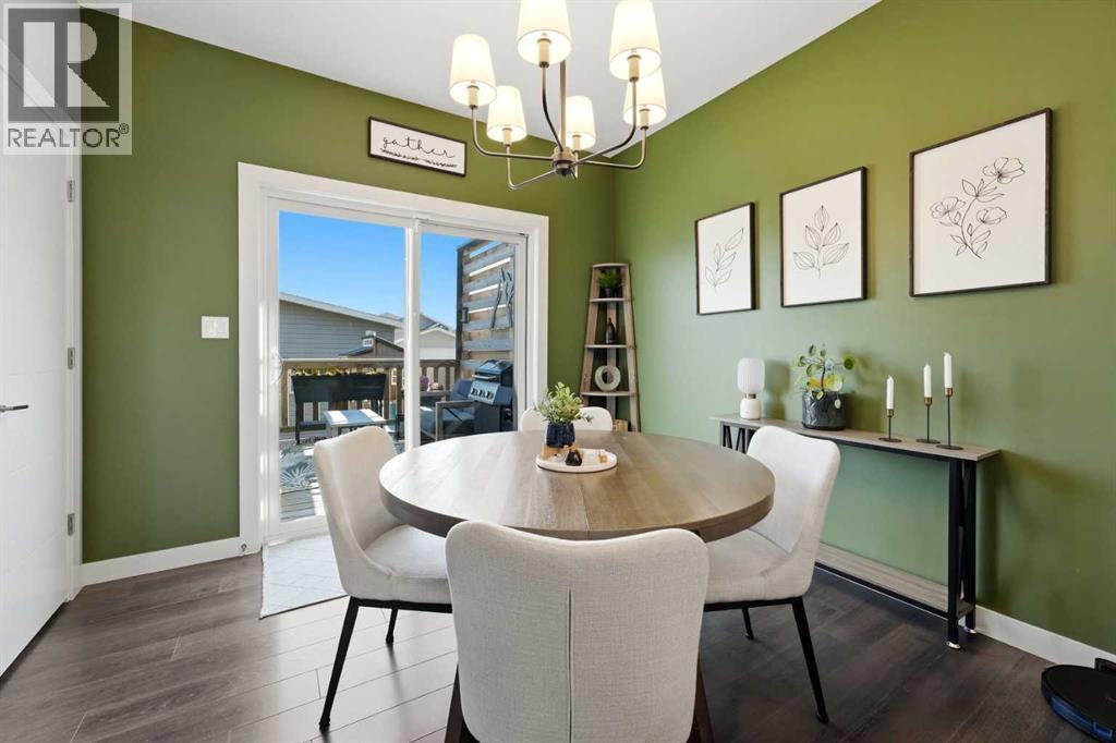 The dining area offers more views of the back deck and yard through the sliding glass door
