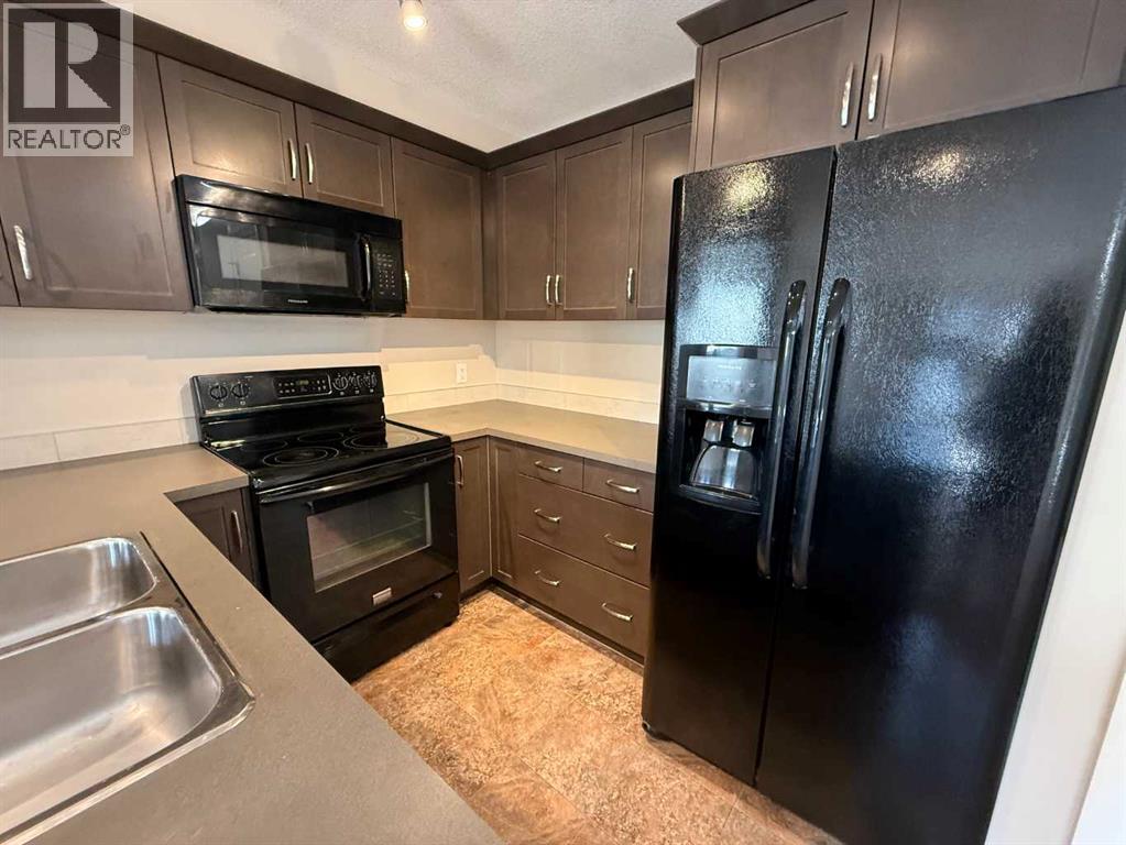 Gourmet Kitchen with warm maple cabinetry and sleek black appliances