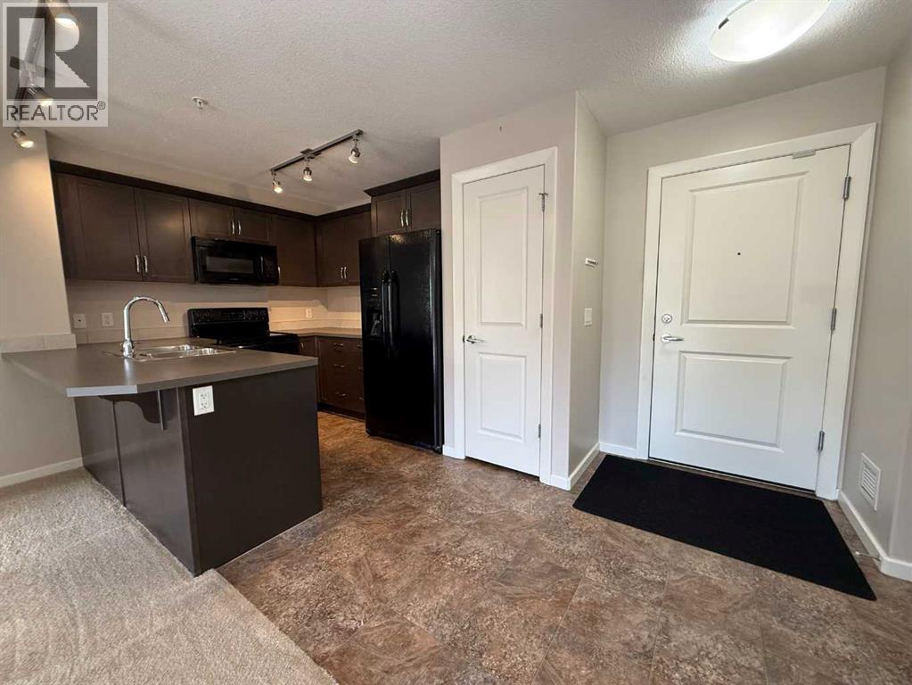 Gourmet Kitchen with warm maple cabinetry and sleek black appliances and Pantry