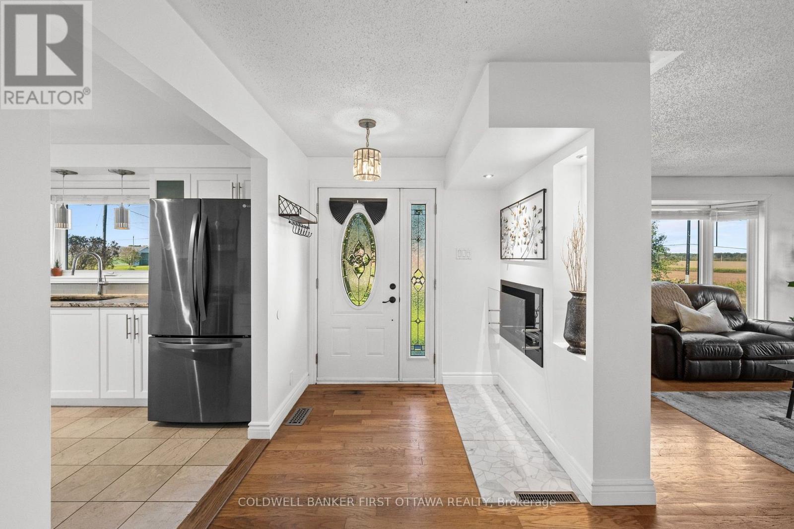 Welcoming front foyer w hanging fixture above.