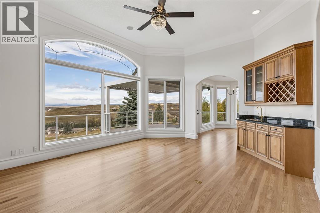 Designed for effortless entertaining, this spacious living area combines hardwood floors, expansive windows and a built-in wet bar, all against an incredible scenic backdrop