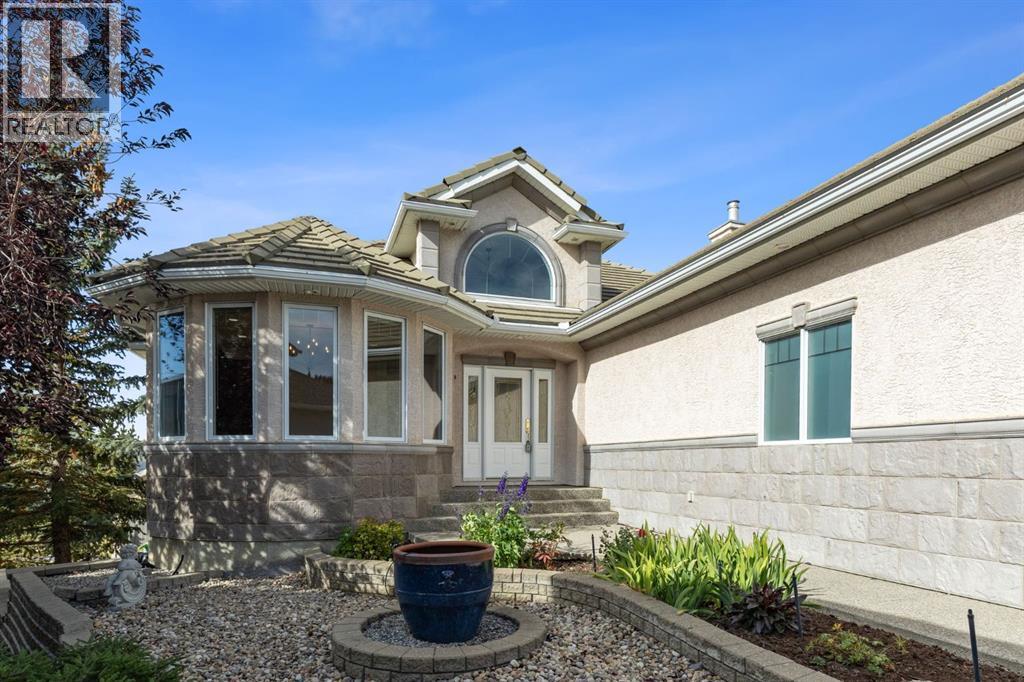 A private, beautifully landscaped approach creates an inviting arrival, with mature greenery, stone accents and striking architectural details leading to the front entrance
