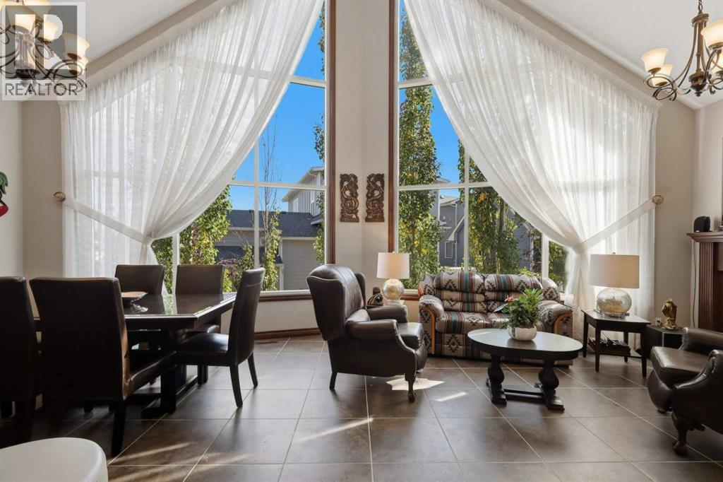 Soaring floor-to-ceiling windows fill the living room with natural light and bring the outdoors in