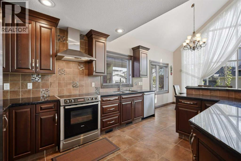 Beautiful custom cabinetry and granite countertops give the kitchen a rich, polished finish