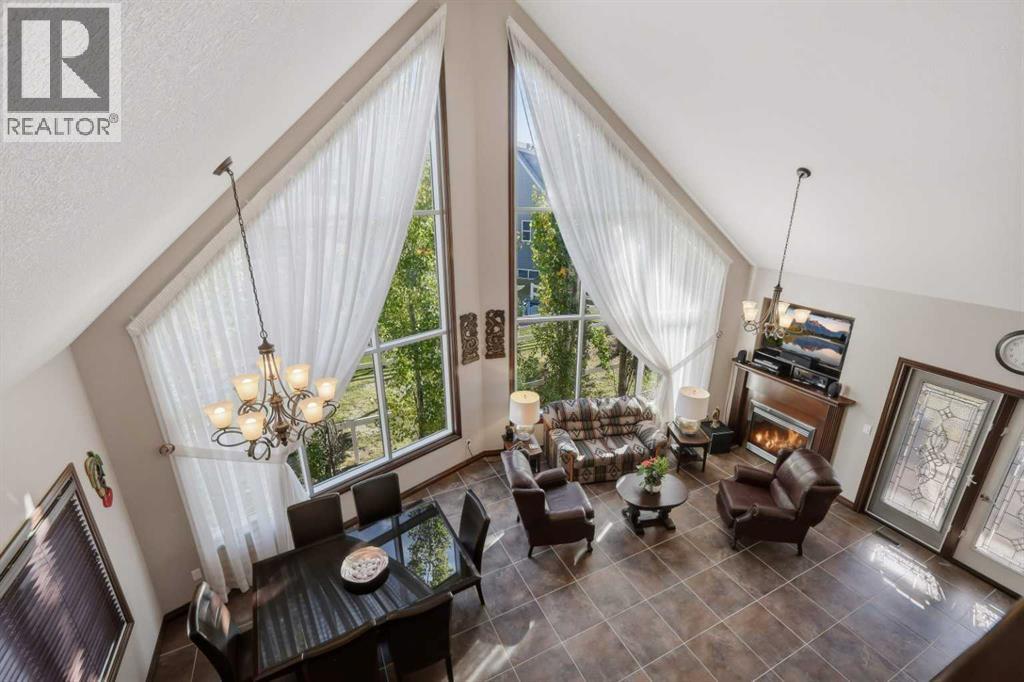 The view from the loft above showcases the dramatic two-storey living room and open-concept design