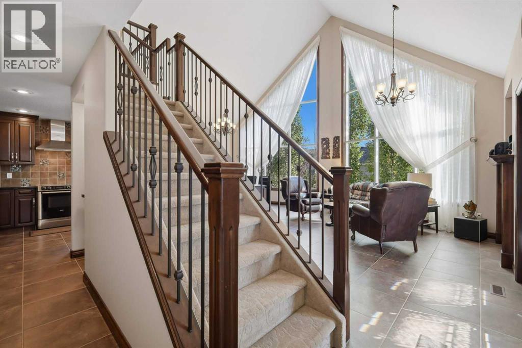 From the front entry, the open layout connects the kitchen and living spaces around the central staircase