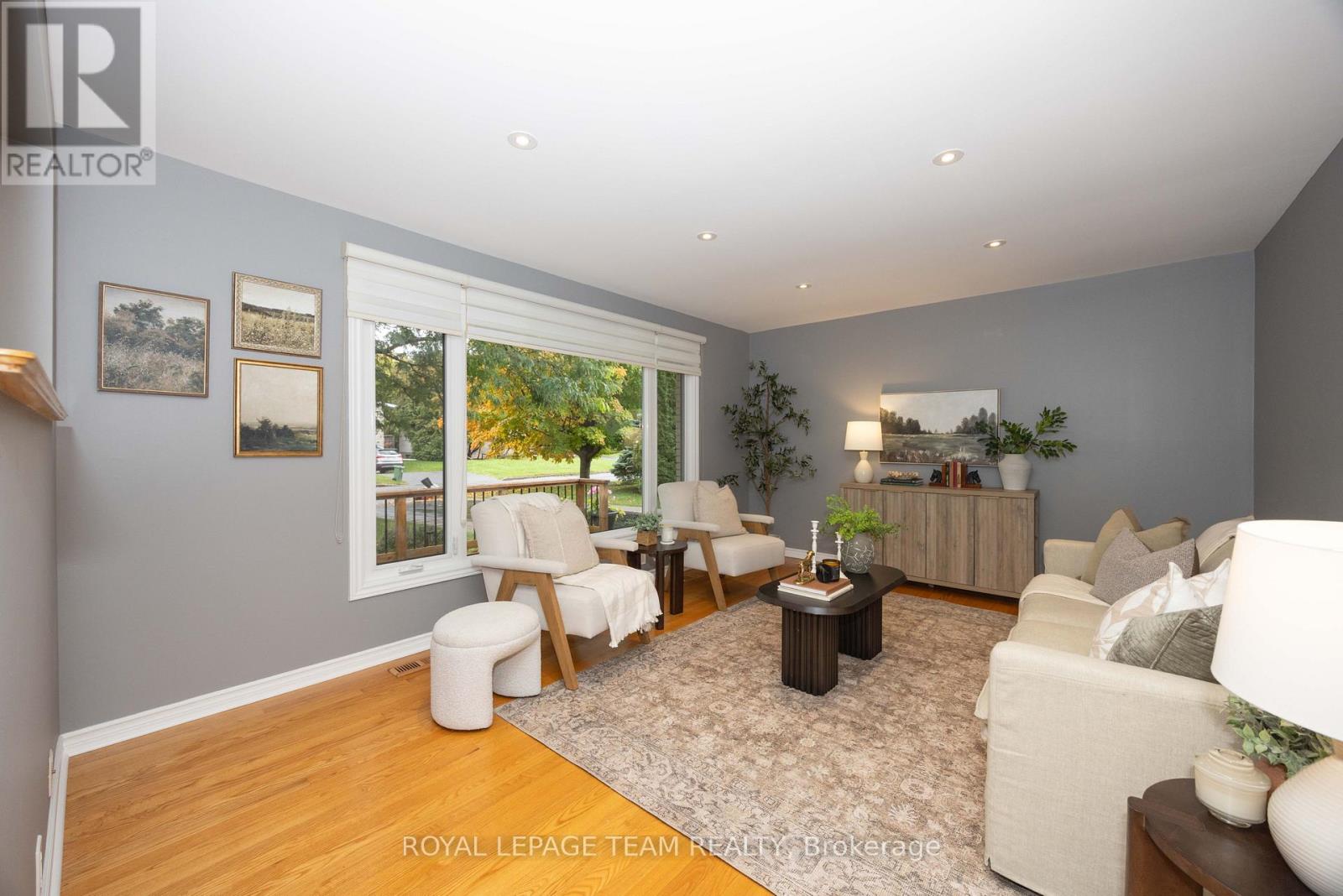 Bright and spacious living room w/ custom blinds