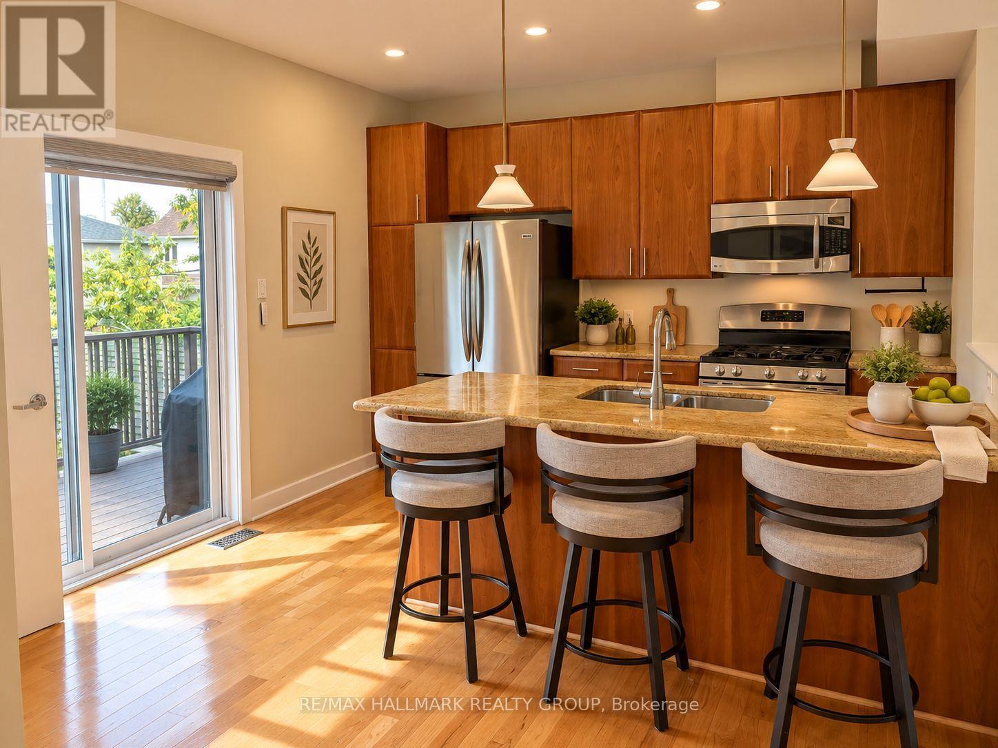 2nd Floor - Kitchen/ Eat-In Bar (Door to Rear Deck