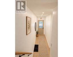 Modern bedroom with bed, armchair, bookshelf, and green views - 54 Thyra Avenue Toronto